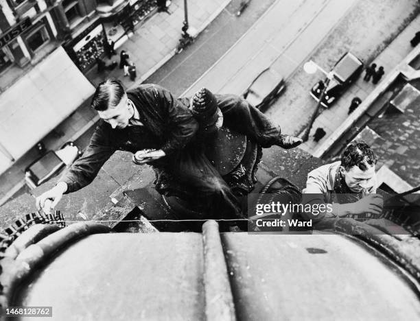 Steeplejacks fixing coloured map bulbs to the pinnacle of the Town Hall, ahead of the Coronation of George VI and Queen Elizabeth, on Commercial...