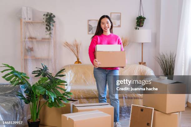 happy woman with box after moving a new house - new content stock pictures, royalty-free photos & images