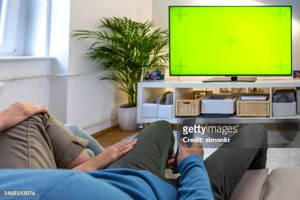 family watching tv - television show stock pictures, royalty-free photos & images