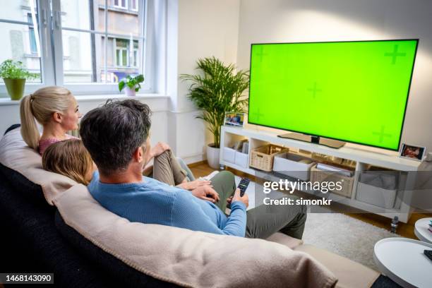 family watching tv - girls television show stock pictures, royalty-free photos & images