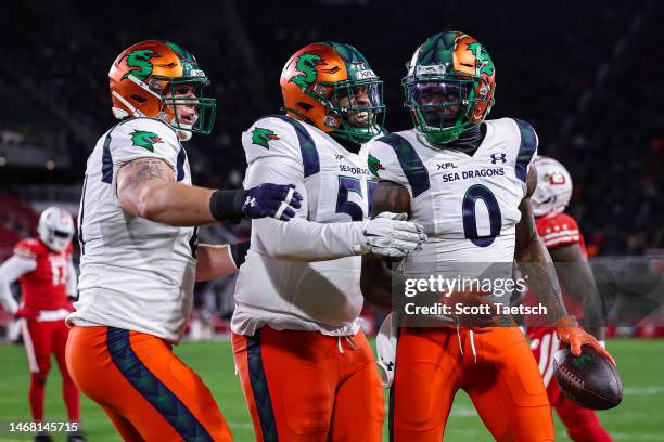 Josh Gordon of the Seattle Sea Dragons celebrates with teammates after catching a pass for a touchdown against the DC Defenders during the first half...