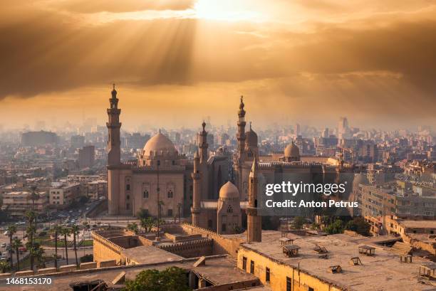 the famous view of cairo at sunset. the mosque-madrasa of sultan hassan - iraq stock pictures, royalty-free photos & images