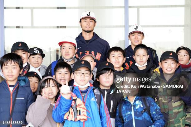 Yu Darvish and Yoshinobu Yamamoto of Samurai Japan pose with fans during a training session on February 21, 2023 in Miyazaki, Japan.