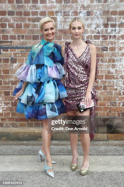 Jessica Rowe and Allegra Overton pose at the Romance Was Born 'Stronger Together' Winter '23 Collection Launch from within Yore's installation WORD...