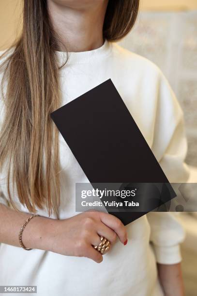 black blank letter in female hand. - flyers business people stockfoto's en -beelden