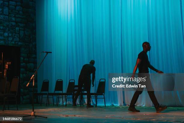 theatre crew arranging chairs on stage set getting ready for stage performance - backstage bildbanksfoton och bilder