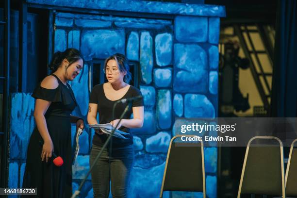 female asian chinese producer and emcee discussion on stage before the concert opening - backstage concert stock pictures, royalty-free photos & images