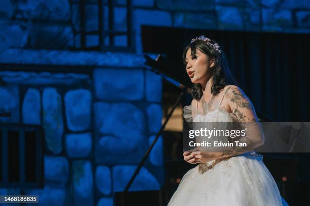 young chinese female opera singer performing solo on stage - sopranos stock pictures, royalty-free photos & images