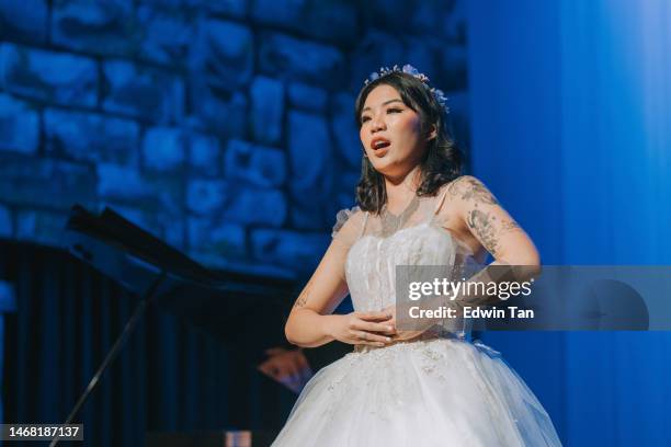 young chinese female opera singer performing solo on stage - opera singing stock pictures, royalty-free photos & images