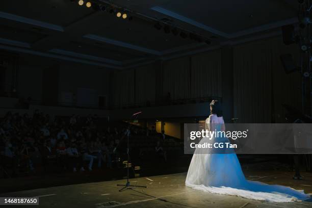 young chinese female opera singer performing solo on stage - opera singer stock pictures, royalty-free photos & images