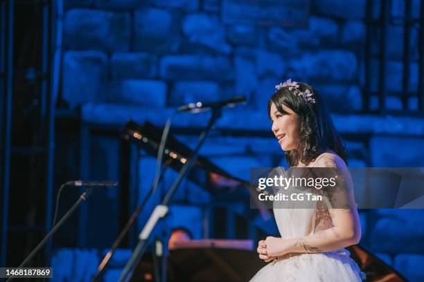 young asian chinese female opera singer performing solo on stage - opera singer stock pictures, royalty-free photos & images