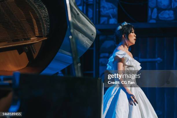 young chinese female opera singer performing solo on stage with pianist - opera singer stock pictures, royalty-free photos & images