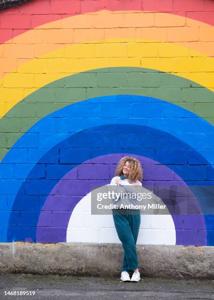 woman standing in front of rainbow - gay pride parade stock pictures, royalty-free photos & images