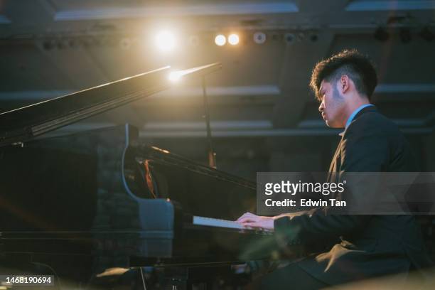 asian chinese teenage boy pianist performing solo on stage - good boy premiere stock pictures, royalty-free photos & images