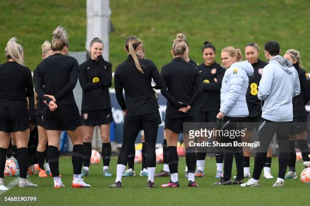 Sarina Wiegman, Manager of England, talks to players of England during a training session at St George's Park on February 21, 2023 in Burton upon...