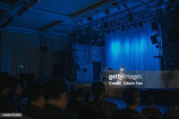 young chinese female opera singer performing solo on stage with pianist in front of audience - soprano singer stock pictures, royalty-free photos & images