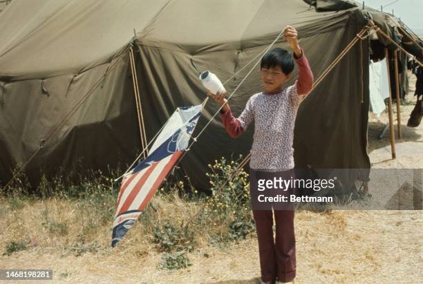 Vietnamese boy flies a kite at Camp Pendleton in California on June 12th, 1975. There are three refugee tent camps at Pendleton, a US Marine Corps...