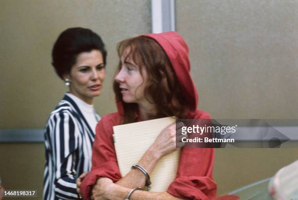 Lynette 'Squeaky' Fromme wears a red robe at the courthouse in Sacramento, California, after being charged with attempting to assassinate President...
