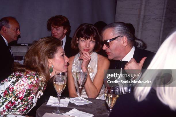 Fore, from left, American socialite Susan Gutfreund, British-American fashion editor & journalist Anna Wintour, and German fashion designer Karl...