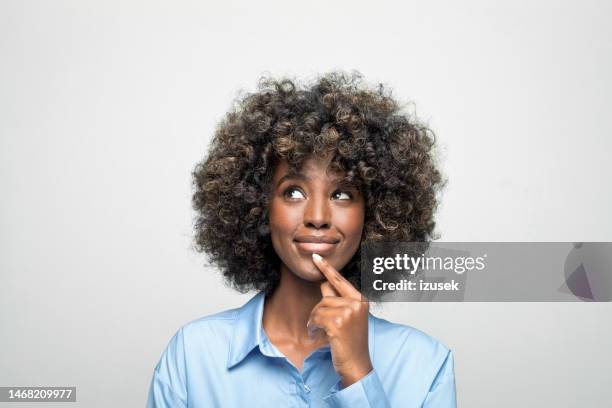 portrait of a thoughtful young businesswoman - reflective imagens e fotografias de stock