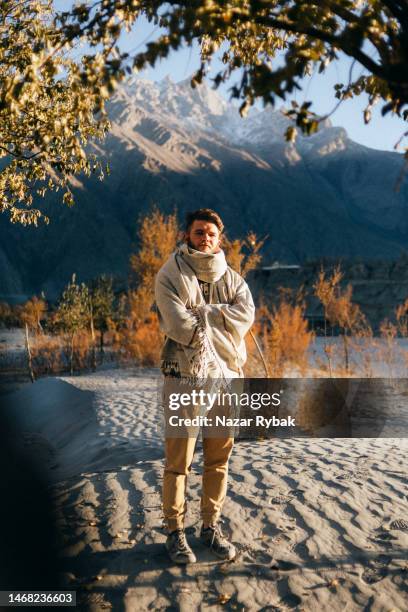 the handsome man wearing in a traditional pakistani shawl in mountains - pashtun stock pictures, royalty-free photos & images