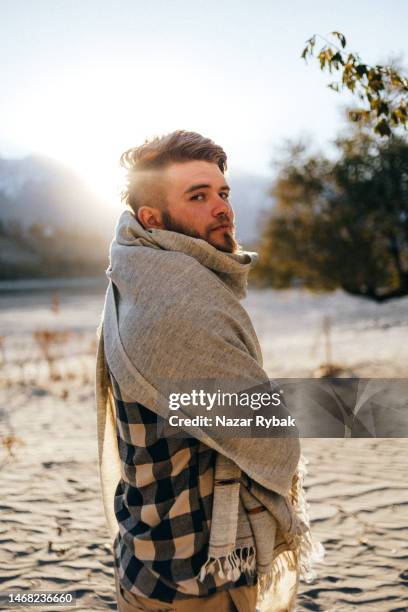 the portrait of a handsome man wearing a traditional pashtun shawl in the background of the scenic mountains at the sunset - pashtun stock pictures, royalty-free photos & images