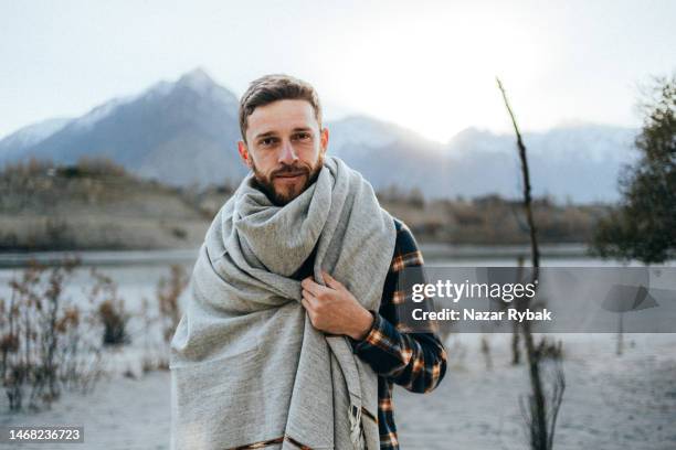 the portrait of a handsome man wearing a traditional pashtun shawl in the background of the scenic mountains at the sunset - pashtun stock pictures, royalty-free photos & images