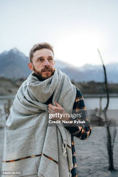 the portrait of a handsome man wearing a traditional pashtun shawl in the background of the scenic mountains at the sunset - pashtun stock pictures, royalty-free photos & images