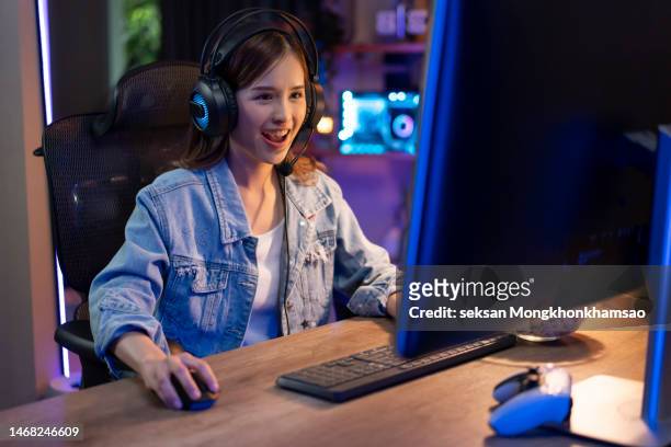 girl plays video game online and streaming at home - downloading stock pictures, royalty-free photos & images