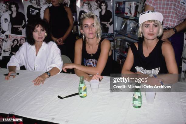 Bananarama; Keren Woodward, Sara Dallin, and Siobhan Fahey during an in-store signing for the band's album 'True Confessions' at a branch of...