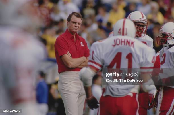 Tom Osborne, Head Coach for the University of Nebraska Cornhuskers looks on from the sideline during the NCAA Big 8 Conference college football game...