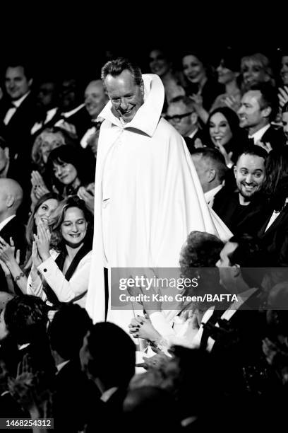 Host, Richard E. Grant speaks on stage during the EE BAFTA Film Awards 2023 at The Royal Festival Hall on February 19, 2023 in London, England.