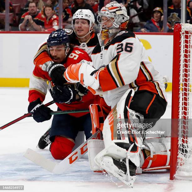 Goaltender John Gibson of the Anaheim Ducks defends the net with the help of teammate John Klingberg against Ryan Lomberg of the Florida Panthers at...
