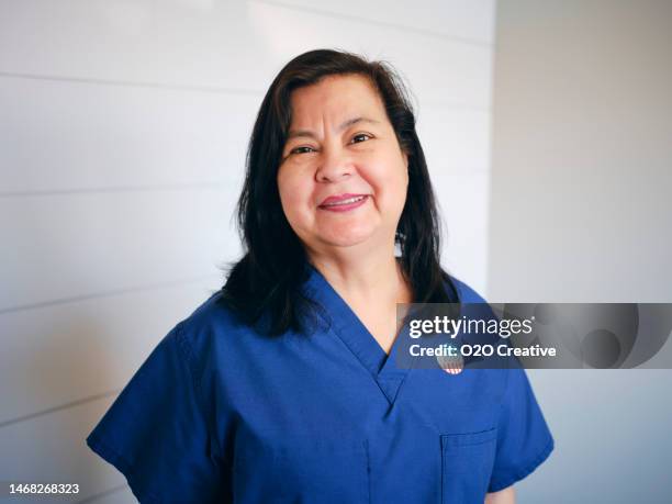 healthcare worker with i voted sticker - medical scrubs stock pictures, royalty-free photos & images
