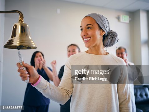 Adult Woman Chemotherapy Patient Finishing Treatment with a Ceremonial Bell Ring