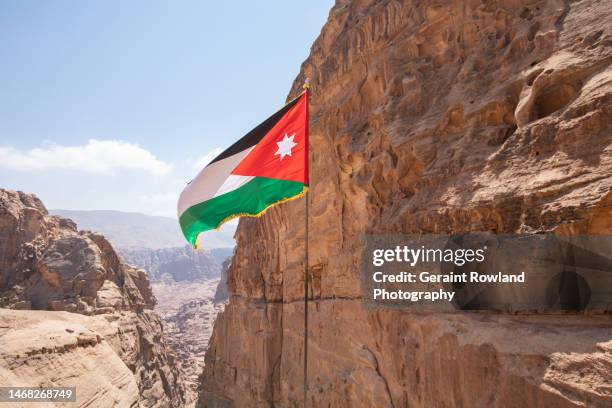 petra, jordan flag flying - jordanian flag stock pictures, royalty-free photos & images