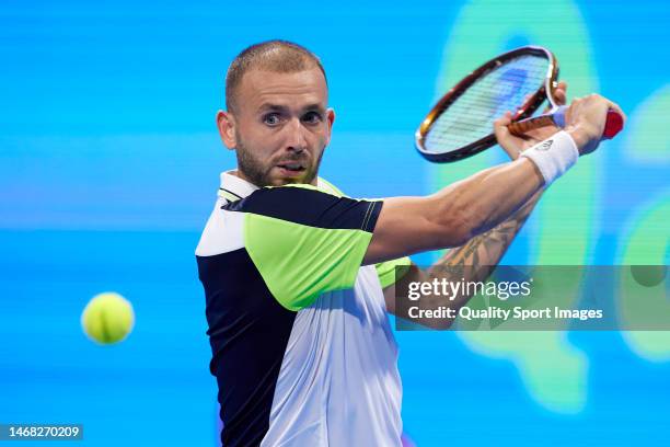 Daniel Evans of Great Britain looks to return a ball against Emil Ruusuvuori of Finland in their Men's Singles match on day two of the Qatar...