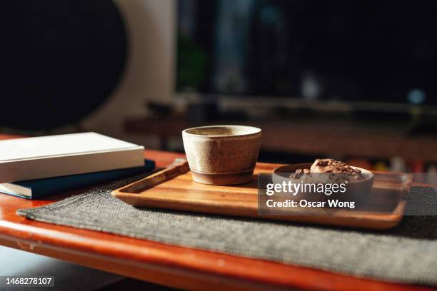 taking a tea break at home - coffee table books stockfoto's en -beelden