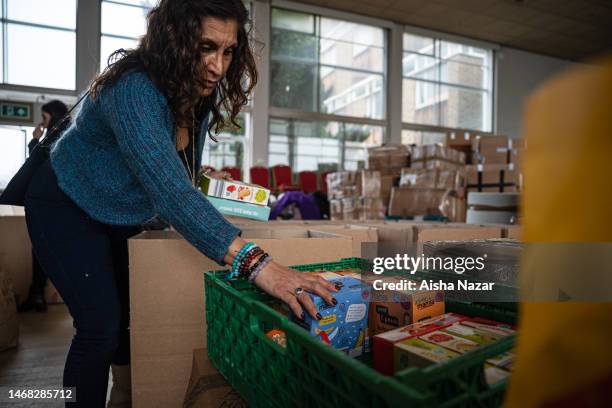 Volunteer organises aid relief for the quake victims at the Turkish Cypriot Community Associations sorting depot on February 21, 2023 in London,...