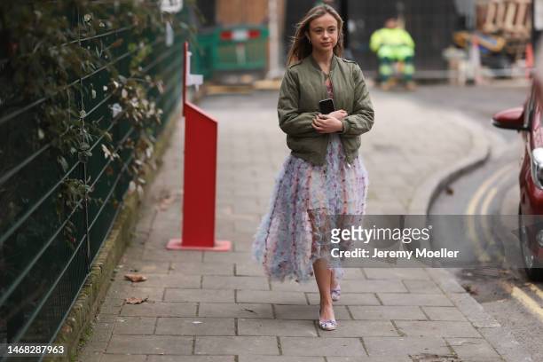 Lady Amelia Windsor seen wearing a colourful light and transparent dress by Susan Fang with matching heels and a green bomber jacket before the SUSAN...