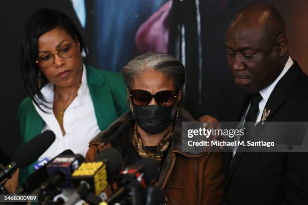 Ilyasah Shabazz places a hand on the shoulder of her sister Qubilah Shabazz shoulder after Civil rights attorney Ben Crump finishes speaking during a...