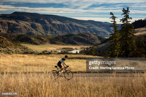 gravel road cycling on scenic back country dirt roads near kamloops, british columbia, canada - thompson okanagan region british columbia stock pictures, royalty-free photos & images