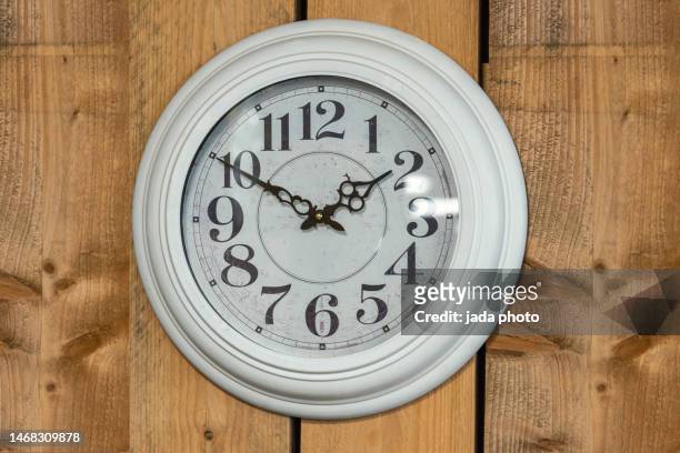 white clock with numbers hanging on a wooden wall - wall clock 個照片及圖片檔
