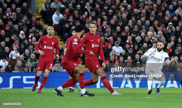 Karim Benzema of Real Madrid scores the team's fourth goal as Virgil van Dijk and Joe Gomez of Liverpool look on during the UEFA Champions League...