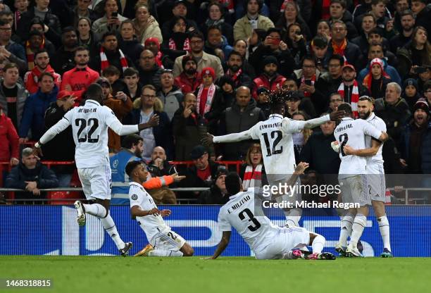 Karim Benzema of Real Madrid celebrates after scoring the team's fourth goal with teammates during the UEFA Champions League round of 16 leg one...