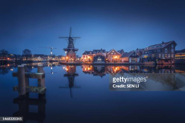 windmill de adriaan at night in haarlem, netherlands - haarlem stock pictures, royalty-free photos & images