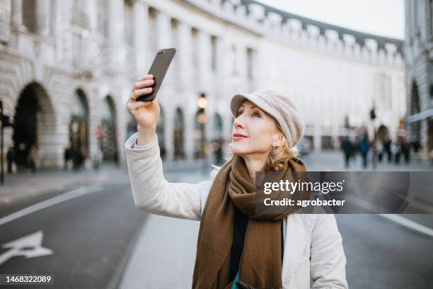 woman taking selfie in city of london - piccadilly circus stock pictures, royalty-free photos & images