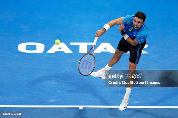 Roberto Bautista of Spain serves against Marton Fucsovics of Hungary in their Men's Singles match on day two of the Qatar ExxonMobil Open at Khalifa...
