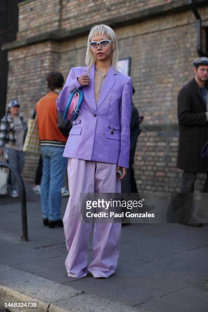Guest is seen wearing a Lilac Suit with a Pair of Silver Sunglasses. JW Anderson during London Fashion Week February 2023 on February 19, 2023 in...