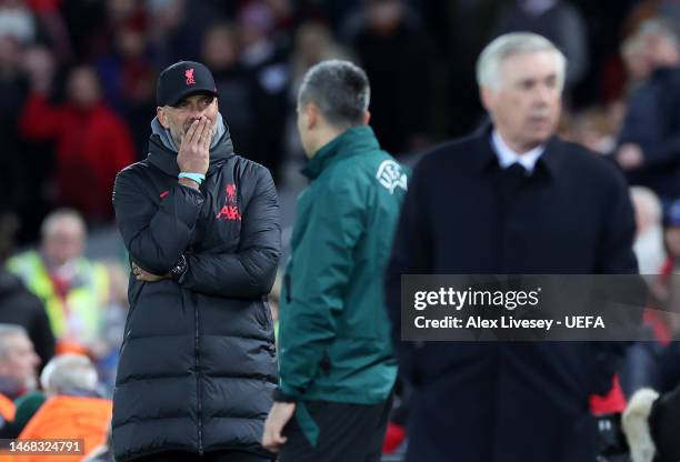Juergen Klopp, Manager of Liverpool, looks dejected as Carlo Ancelotti, Manager of Real Madrid, looks on during the UEFA Champions League round of 16...